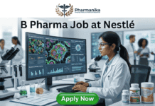 B Pharma Job at Nestlé | Apply For Nutrition Officer Role Today A professional and vibrant featured image for a job post titled "B Pharma Job at Nestlé." The image depicts a young female scientist of Indian descent wearing a white lab coat and safety glasses, working in a modern, brightly lit laboratory. She is smiling while looking at a large computer monitor that displays complex biological data and molecular visualizations. On her desk are various nutritional products, including bottles labeled "Multi-Vitamin" and "Nutritional Powder," alongside laboratory glassware and scientific documents. The Biotecnika logo is placed at the top center, and a prominent green "APPLY NOW" button is located at the bottom.