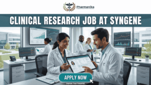 Latest Clinical Research Job at Syngene Apply Today! Latest Clinical Research Job at Syngene Apply Today! A featured image for a job page, part of Biotecnika, showcasing a clinical research position at Syngene. At the top center is the Biotecnika logo, with the text 'Your Bio Resource'. The main bold title is 'CLINICAL RESEARCH JOB AT SYNGENE'. The background features a detailed, realistic photograph of a diverse team of five scientists and professionals (two women, three men) collaborating in a modern, well-equipped laboratory, looking collaboratively into a computer monitor showing data charts, graphs, and a detailed 3D molecular structure. The lab has advanced scientific instruments, beakers, and shelves, visible next to a large window. The overall scene conveys scientific innovation, teamwork, and professionalism. At the bottom center, there is a prominent orange rectangular button labeled 'Apply now'.