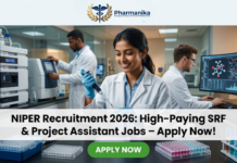 NIPER Recruitment 2026: SRF & Project Assistant Job Openings | Earn Upto ₹42,000 + 20% HRA/month – Apply Now! NIPER Recruitment 2026 High-Paying SRF & Project Assistant Jobs – Apply Now! A professional featured image for a job post titled "NIPER Recruitment 2026: High-Paying SRF & Project Assistant Jobs – Apply Now!" The image shows a smiling Indian woman scientist in a white lab coat using a pipette in a modern, high-tech laboratory. In the background, other researchers work with advanced scientific equipment and computer monitors displaying molecular data. The Biotecnika logo is at the top center, and a prominent green "APPLY NOW" button is positioned at the bottom.